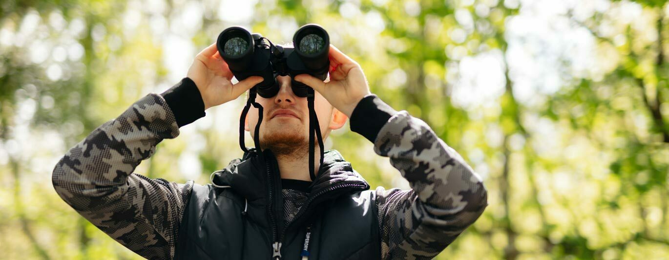 Enviro banner Environmental Studies degree student looking through binoculars