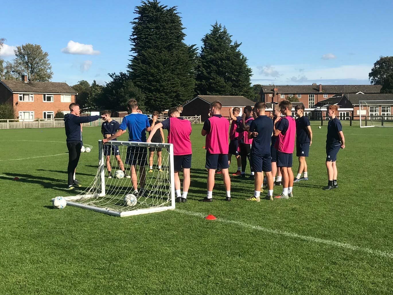 Academy student coaching football team