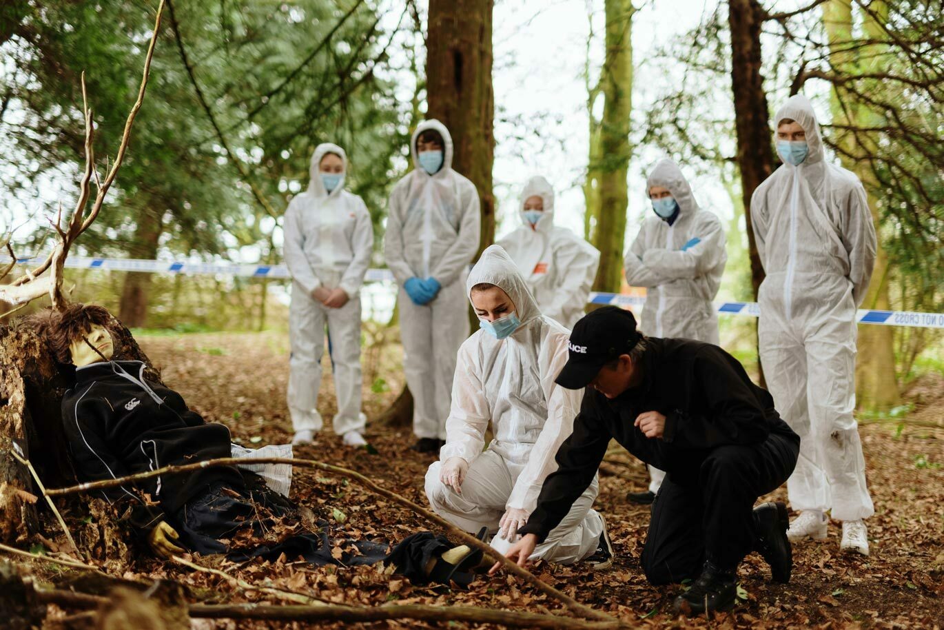 Forensic gallery Forensic Science students examining crime scene in woodland