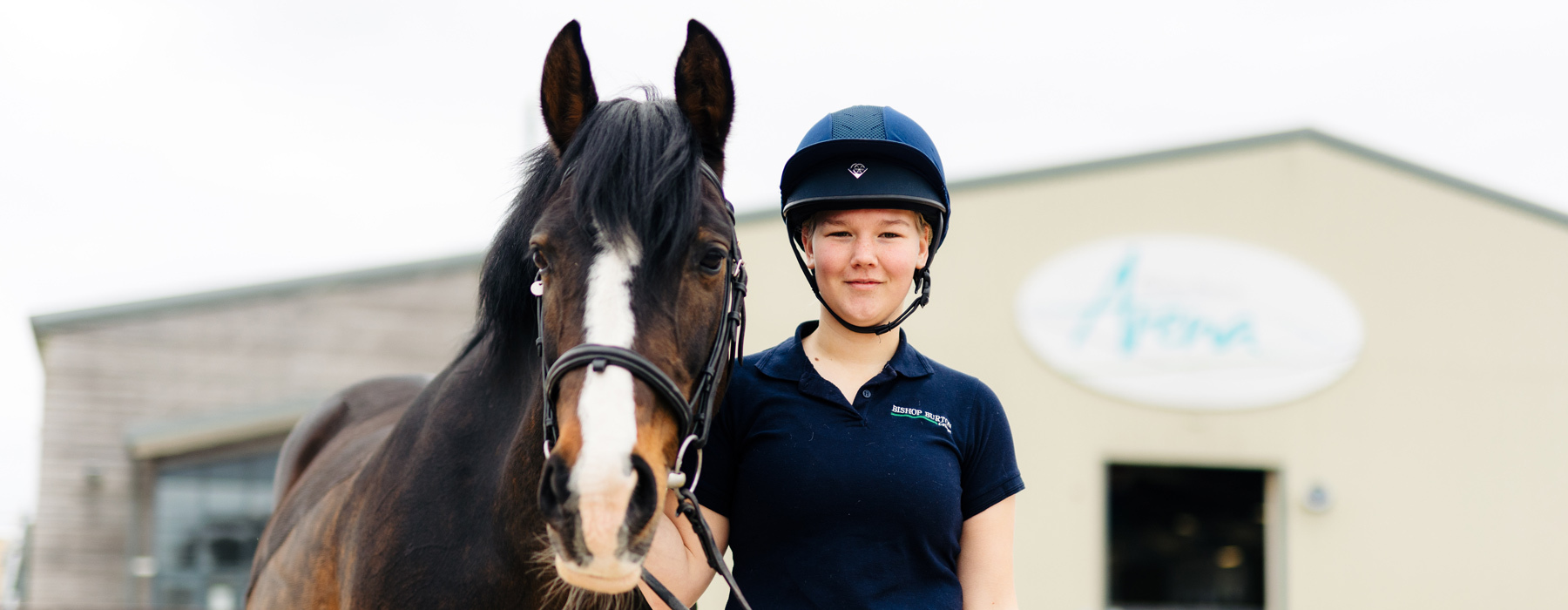 Student and horse stood outside Bishop Burton Arena