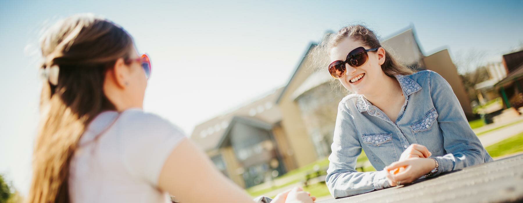 Students sat at picnic bench smiling