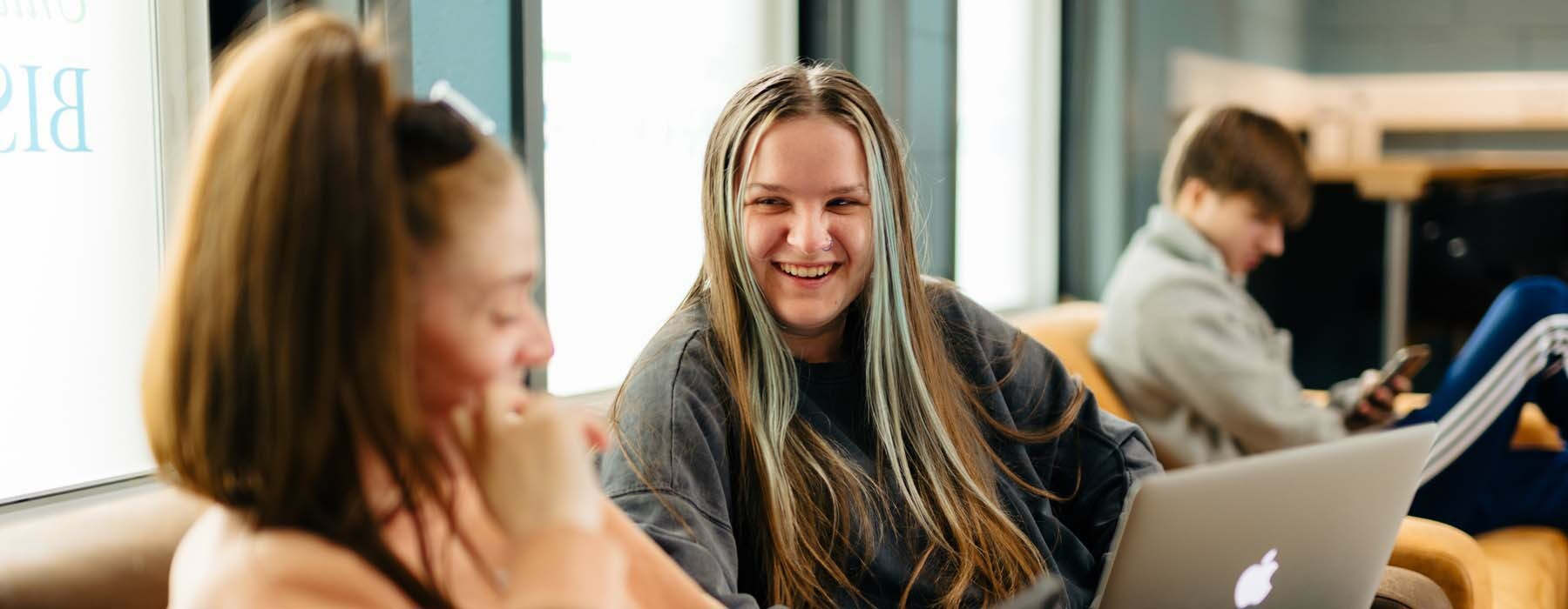 Term dates banner Students laughing in University Centre lounge