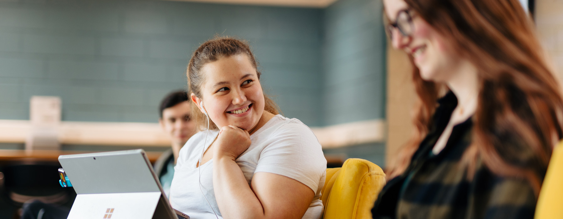 UCBB student smiling in Higher Education Lounge